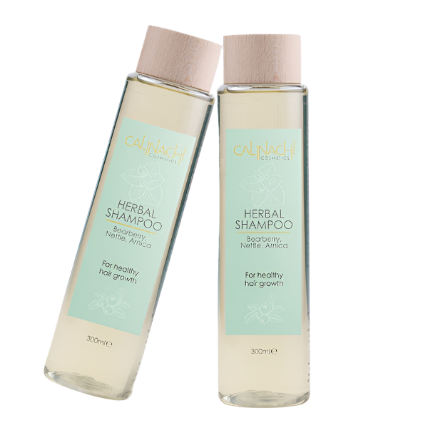 Two bottles of Herbal Shampoo by Calendula Cosmetics on a white background
